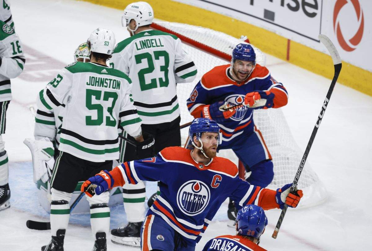 Dallas Stars forward Wyatt Johnston (53) and defenceman Esa Lindell (23) look away as Edmonton Oilers forward Connor McDavid (97) celebrates his goal with teammate forward Zach Hyman (18) during first period of Game 6 of the Western Conference finals of the NHL hockey Stanley Cup playoffs in Edmonton, Sunday, June 2, 2024.