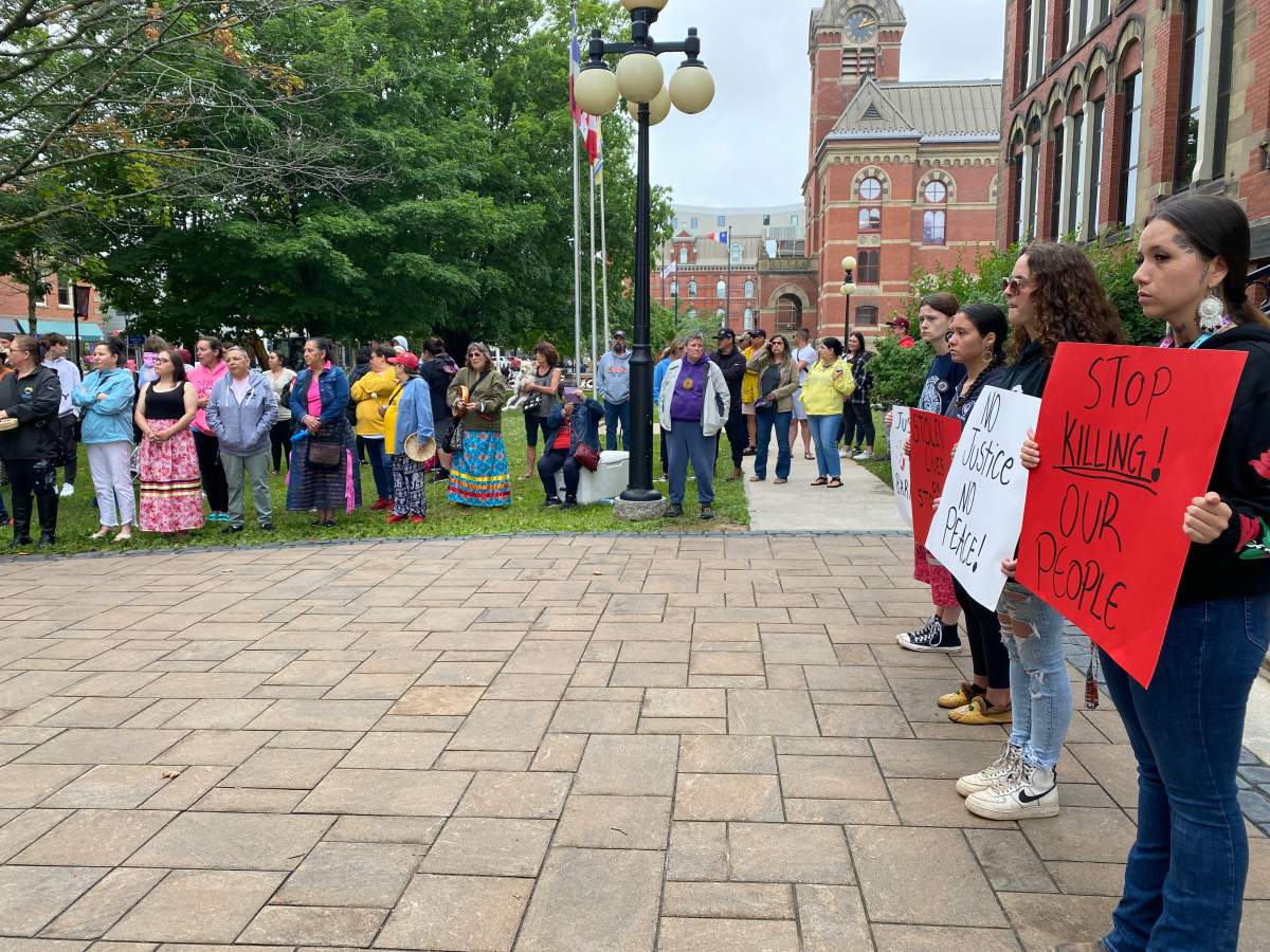 Barnzie's family and friends surrounded his son to show their support outside the Fredericton courthouse.