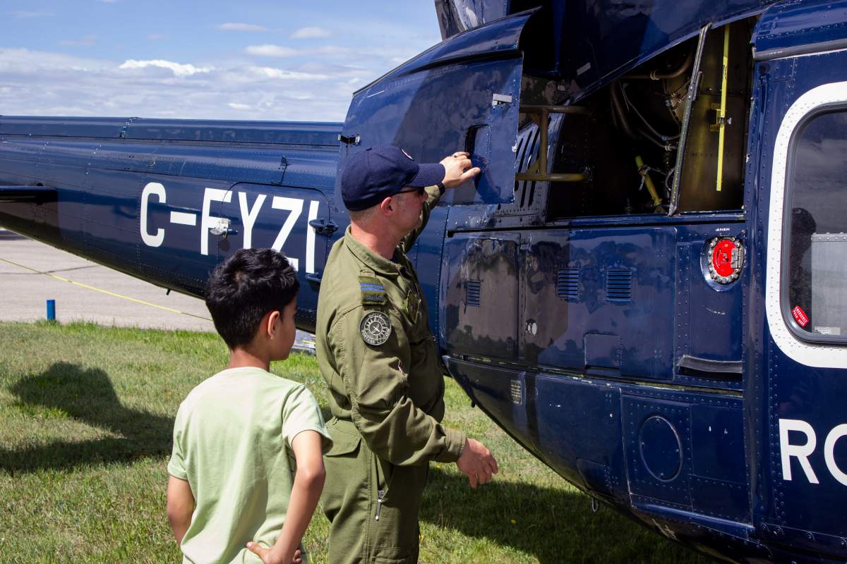 One member of the Canada Sea King team shows off one of the helicopters engines.