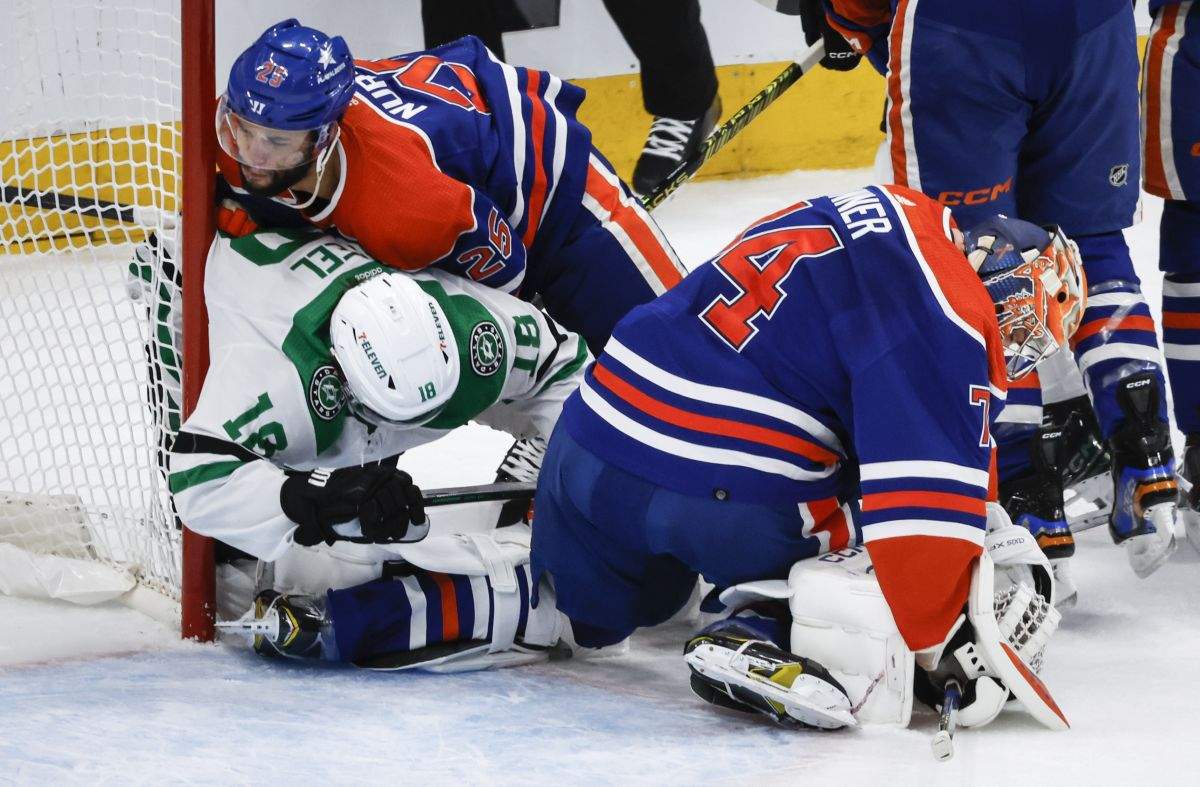 Dallas Stars forward Sam Steel (18) is checked by Edmonton Oilers defenceman Darnell Nurse (25) as goalie Stuart Skinner (74) holds onto the puck during first period of Game 6 of the Western Conference finals of the NHL hockey Stanley Cup playoffs in Edmonton, Sunday, June 2, 2024.