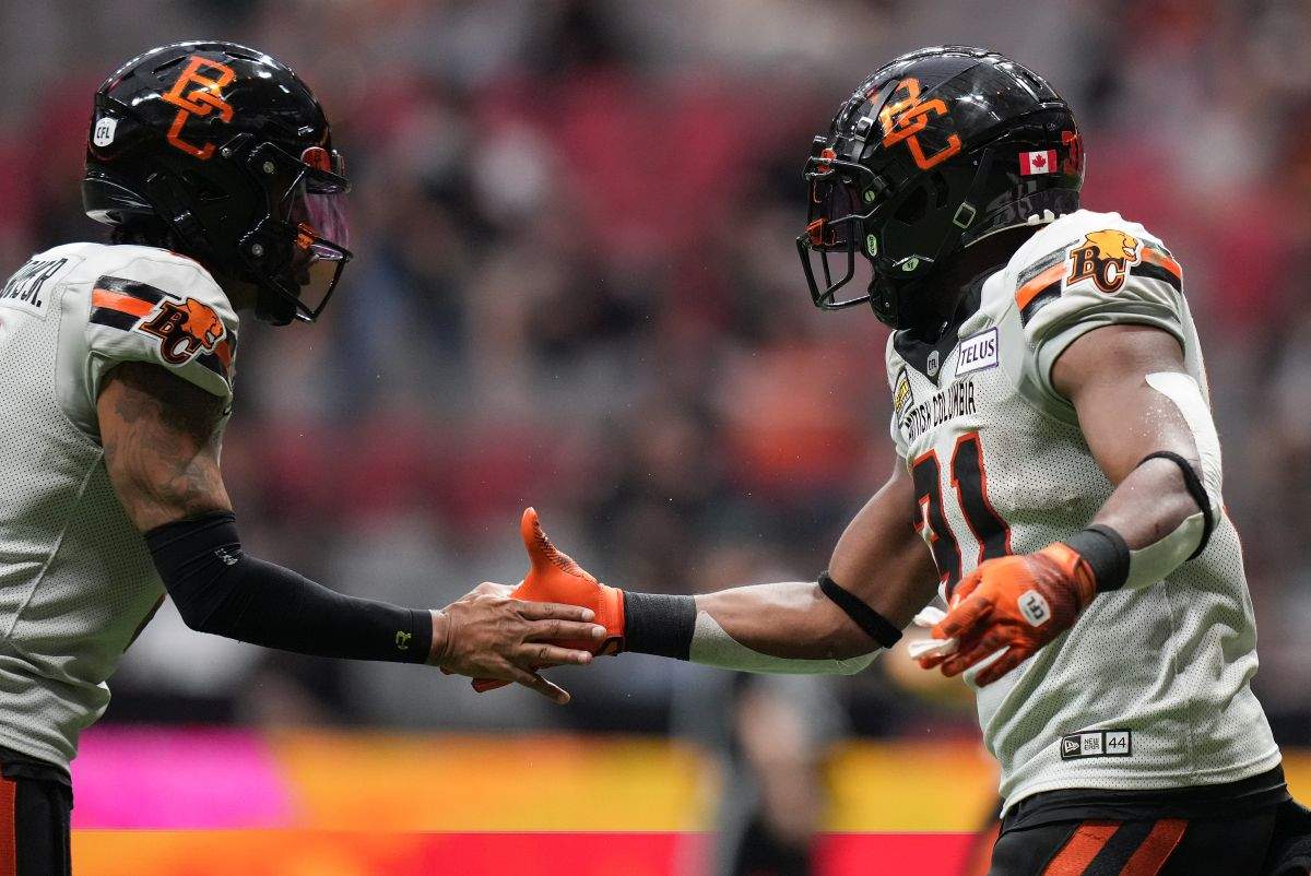 B.C. Lions quarterback Vernon Adams Jr., left, and William Stanback celebrate Stanback's touchdown against the Edmonton Elks during the first half of a preseason CFL football game, in Vancouver, on Friday, May 31, 2024.