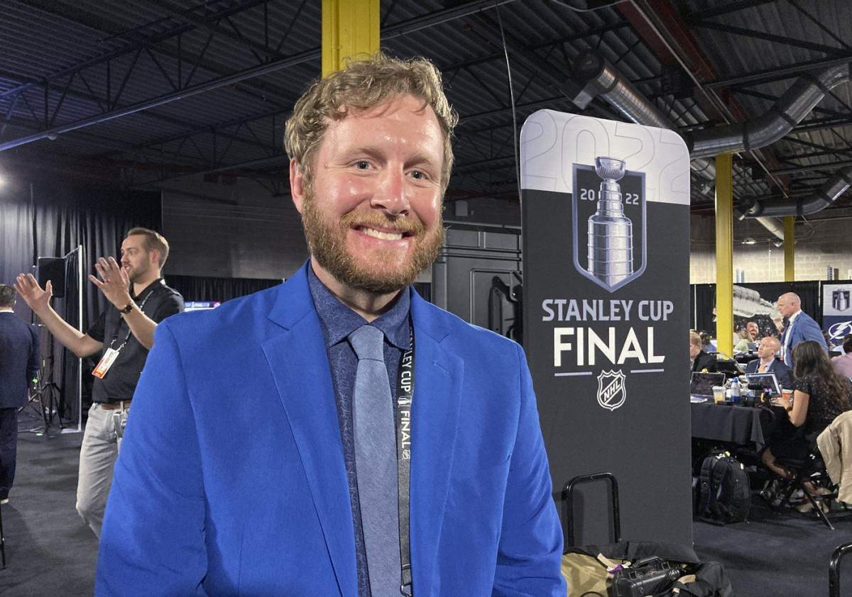 Brice Christianson poses for a photo after interpreting NHL Commissioner Gary Bettman's annual state of the league news conference from English into American Sign Language, June 15, 2022, at Ball Arena in Denver before Game 1 of the NHL hockey Stanley Cup Final.