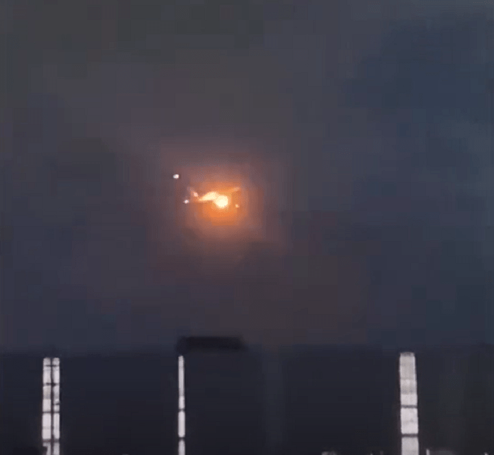 The aircraft with an orange glow from the engine fire about to land at Toronto Pearson Airport.