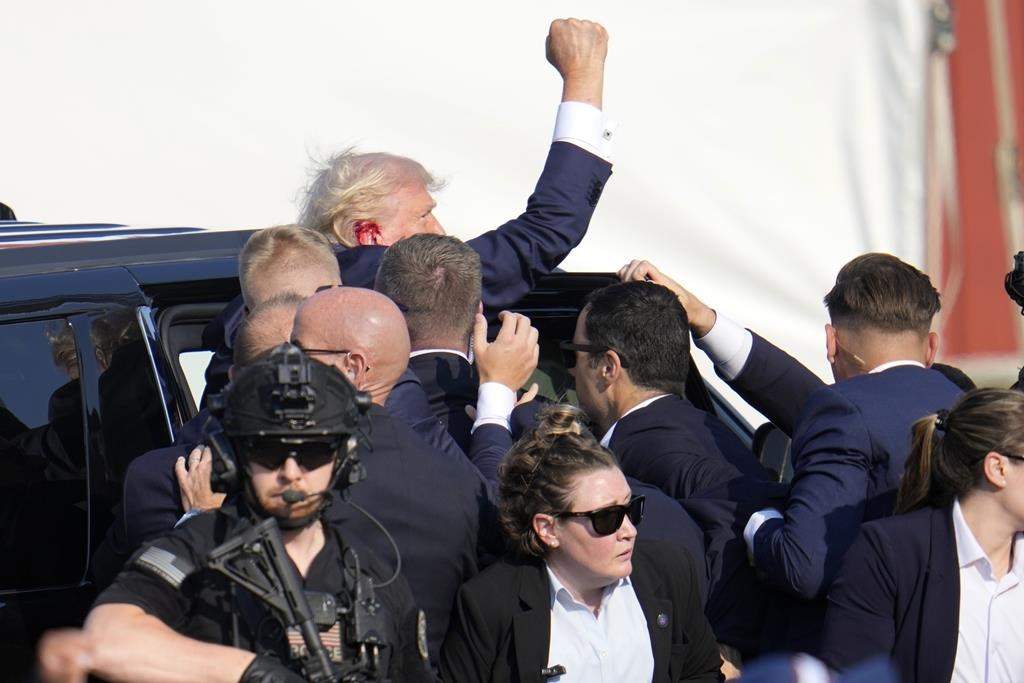 Republican presidential candidate former President Donald Trump is helped off the stage at a campaign event in Butler, Pa., on Saturday, July 13, 2024.