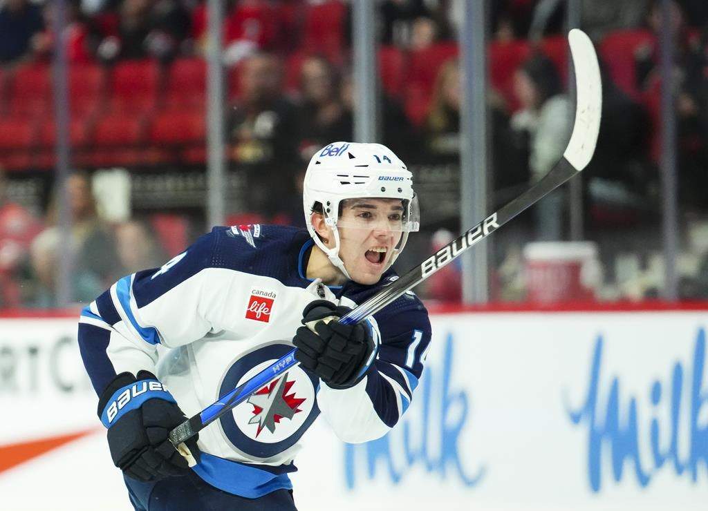 Winnipeg Jets defenceman Ville Heinola (14) takes a shot on net while taking on the Ottawa Senators in first-period pre-season NHL hockey action in Ottawa on Sept. 29, 2023.