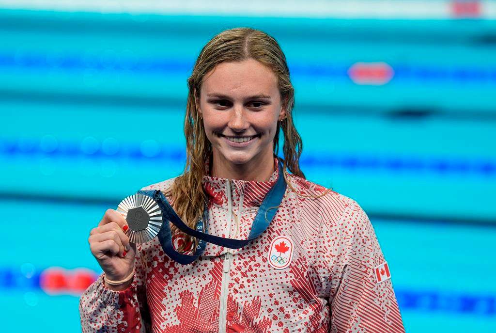 Summer McIntosh, of Canada, smiles as she holds her silver medal after the women's 400-metre freestyle final at the 2024 Summer Olympics, Saturday, July 27, 2024, in Nanterre, France. THE CANADIAN PRESS/Adrian Wyld.