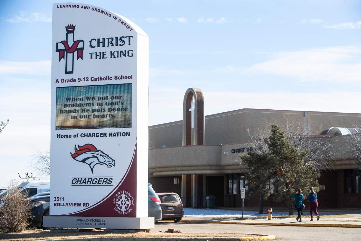 People leave a school after a student was airlifted to hospital after an attack at a school in Leduc, Alta., on March 15, 2021. 