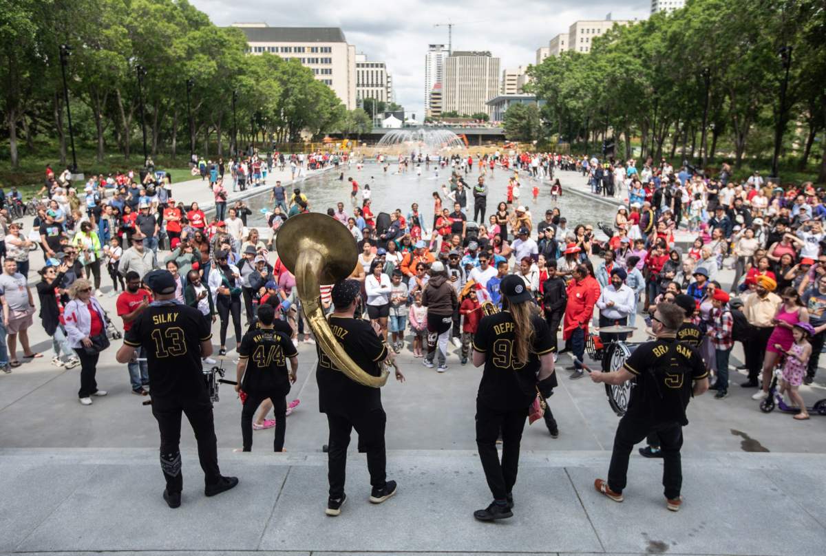 The Brasstactics play for people during Canada Day celebrations in Edmonton on Monday July 1, 2024. THE CANADIAN PRESS/Jason Franson