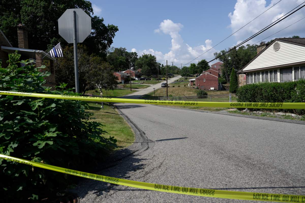 Police tape blocks a street in Bethel Park, Pa., that they say is near a residence of Thomas Matthew Crooks, the suspected shooter of former President Donald Trump, Sunday, July 14, 2024.