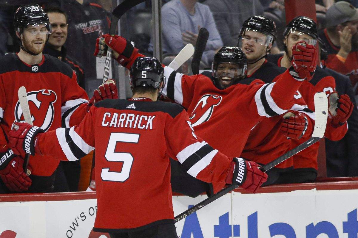 New Jersey Devils defenceman Connor Carrick (5) celebrates with defenceman P.K. Subban, centre right, during the second period of an NHL hockey game against the St. Louis Blues, Friday, March 6, 2020, in Newark.