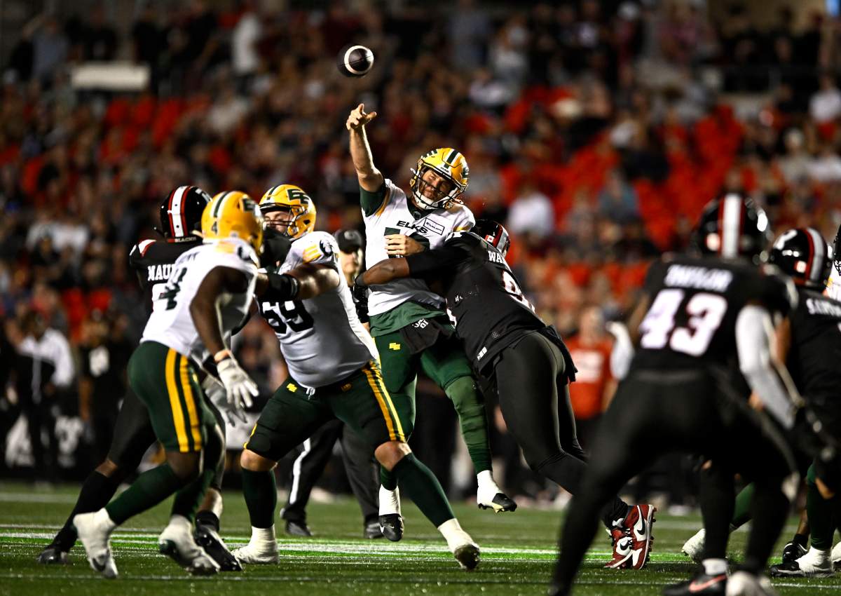 Edmonton Elks quarterback McLeod Bethel-Thompson (10) is sacked by Ottawa Redblacks' Michael Wakefield (96) as he throws the ball, during second half CFL football action in Ottawa on Friday, July 19, 2024.