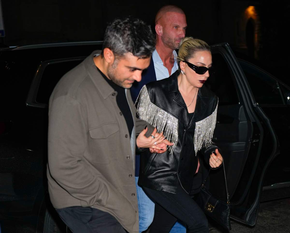 Lady Gaga and Michael Polansky hold hands.