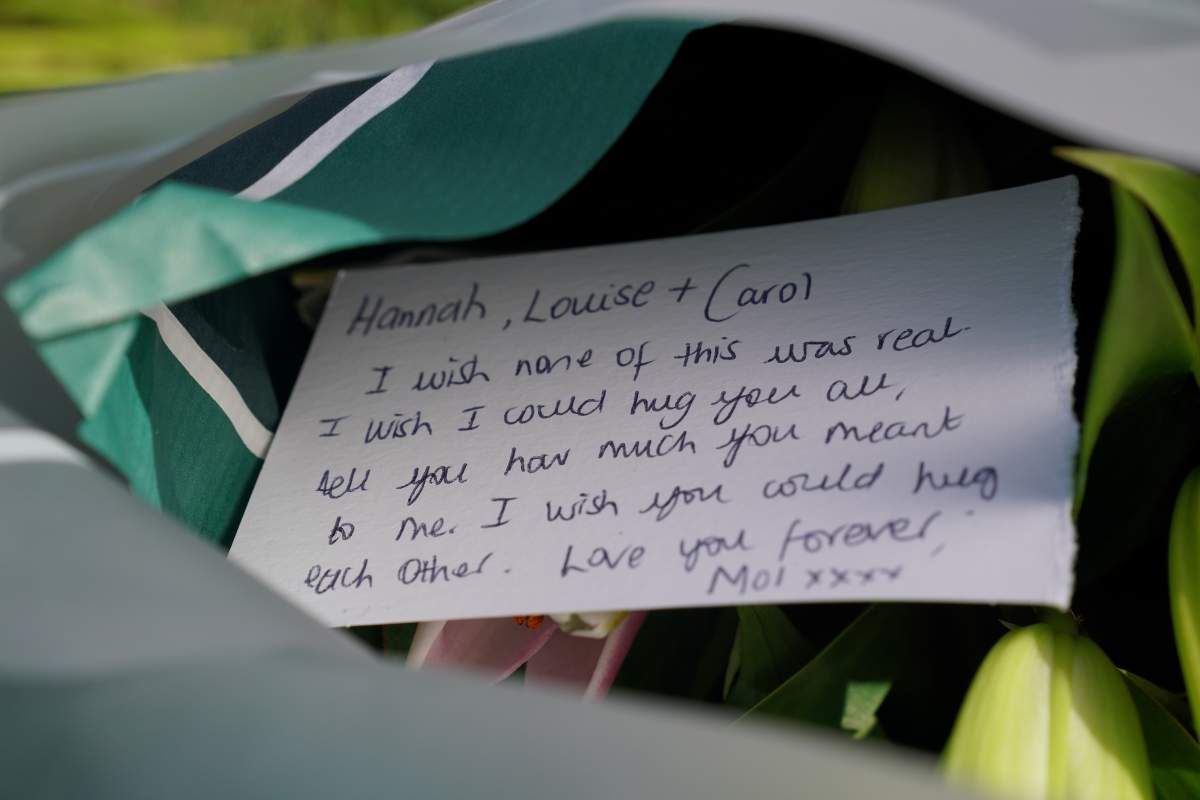 A sympathy note written in pen on white cardstock.