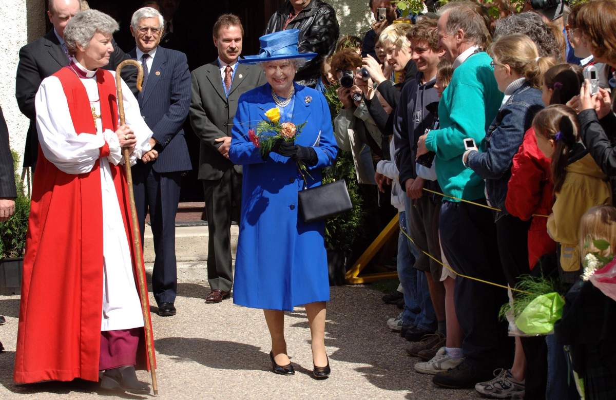 Britain’s Queen Elizabeth II departs St Mary’s and St. George Anglican Church, accompanied by the Reverend Victoria Matthews, the bishop of Edmonton.