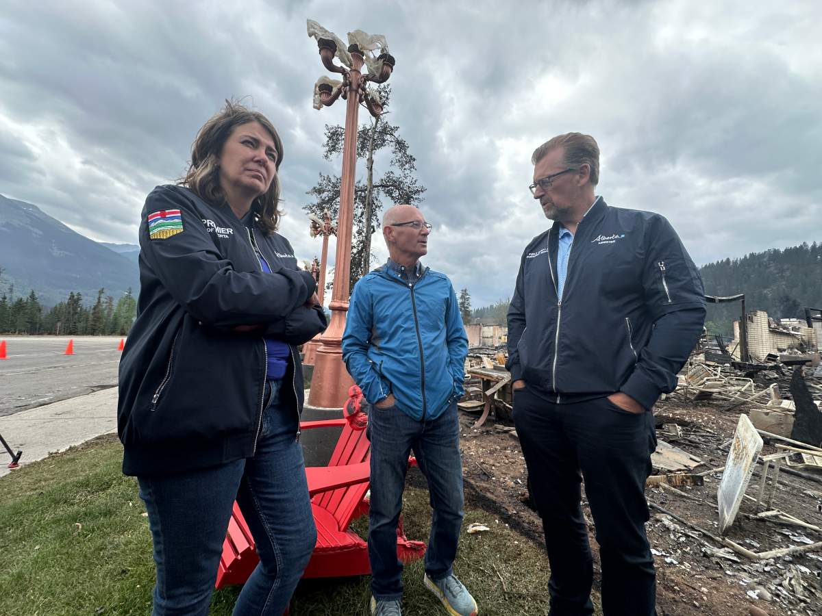 Premier Danielle Smith, Jasper Mayor Richard Ireland and Public Safety Minister Mike Ellis observing wildfire damage in Jasper, Alta. on Friday, July 26, 2024.