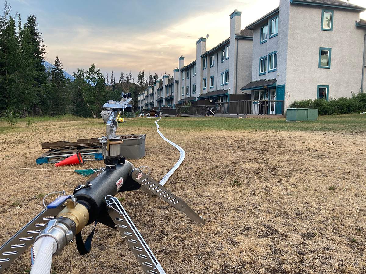 Sprinklers set up at the townside inside Jasper National Park in July 2024.