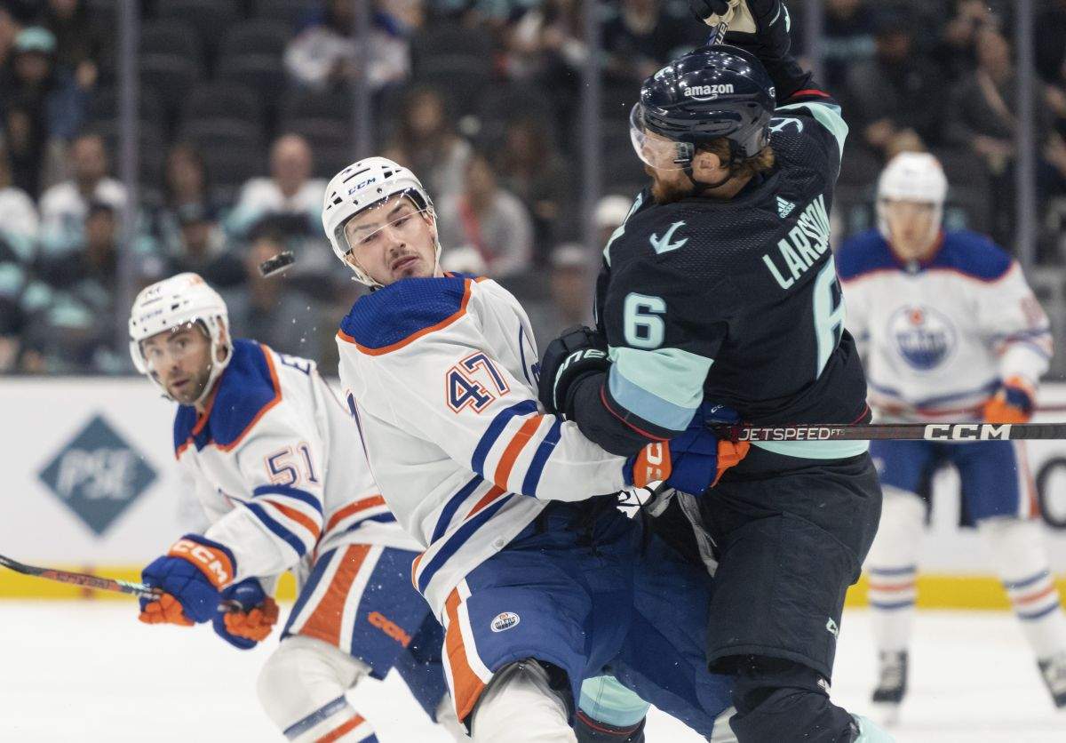 Seattle Kraken defenceman Adam Larsson check Edmonton Oilers forward Noah Philp during the second period of a preseason NHL hockey game, Monday, Sept. 26, 2022, in Seattle.