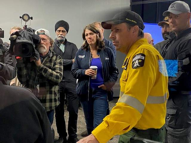 Alberta Premier Danielle Smith, federal Minister of Emergency Preparedness Harjit Sajjan and provincial Forestry Minister Todd Loewen visit the Hinton wildfire command centre on Friday, July 26, 2024.
