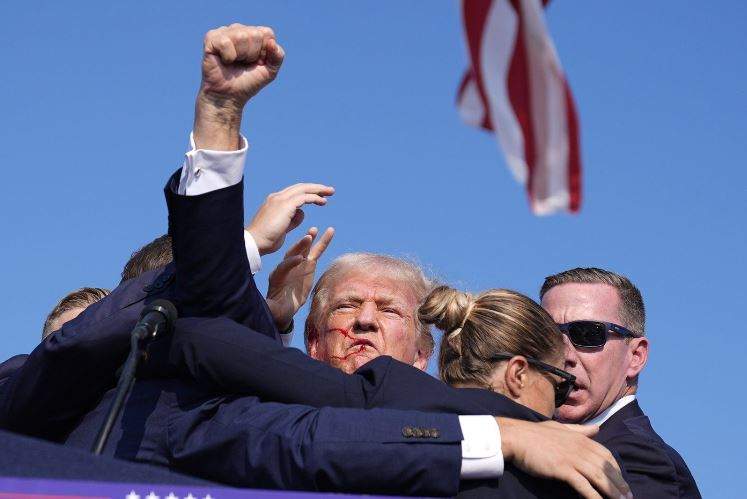Republican presidential candidate former President Donald Trump is surrounded by U.S. Secret Service agents at a campaign rally, Saturday, July 13, 2024, in Butler, Pa.