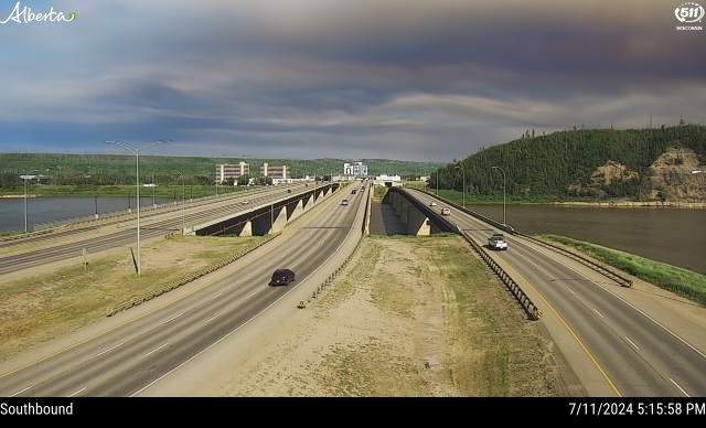 A southbound traffic camera image from Highway 63 and Memorial Bridge in Fort McMurray showing wildfire smoke moving in on Thursday, July 11, 2024.