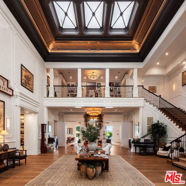 Two-storey entryway with an exposed view of the second floor and a wrap-around staircase.