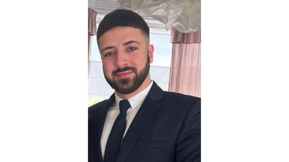 Kyle Clifford. He has short hair and is wearing a black suit.
