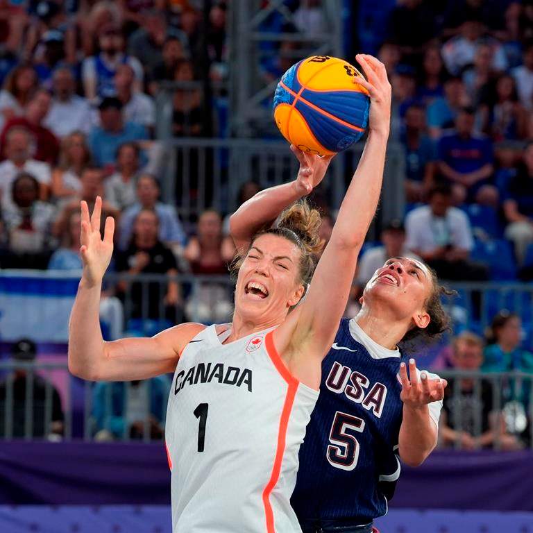 Canada's Michelle Plouffe (1) is fouled by United States Dearica Hamby (5) during the women's 3 X 3 basketball bronze medal game at the Summer Olympics in Paris on Monday, Aug. 5, 2024. THE CANADIAN PRESS/Adrian Wyld.