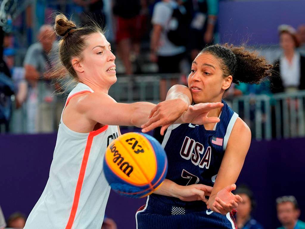 Canada's Michelle Plouffe (left) and United States Cierra Burdick (7) battle for the ball during the women's 3 X 3 basketball bronze medal game at the Summer Olympics in Paris on Monday, Aug.5, 2024. 