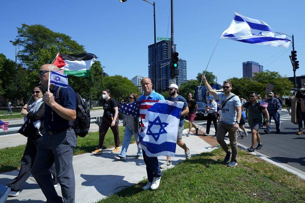 Counter-protesters arrive at Union Park before a march to the Democratic National Convention Monday, Aug. 19, 2024, in Chicago. (AP Photo/Julio Cortez)