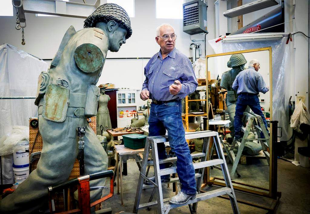 Bronze sculptor Don Begg, makes adjustments to a bronze statue depicting a Second World War Canadian soldier. Begg will be receiving the Alberta Order of Excellence for his work over the decades and is pictured in his workshop in Cochrane, Alta., Monday, Aug. 19, 2024.THE CANADIAN PRESS/Jeff McIntosh.