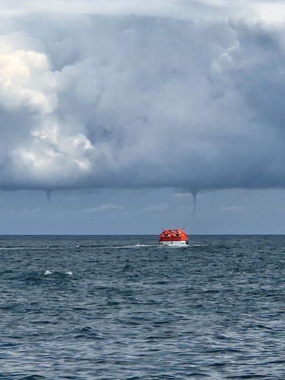 The Northern Tornadoes Project has confirmed several waterspouts were recorded in Ontario, Quebec and Nova Scotia during the month of August. Two waterspouts form in the distance as a vessel, foreground, is seen in the waters near Îles-de-la-Madeleine, Que., in a Friday, Aug. 23 handout photo. THE CANADIAN PRESS/HO-Marc-Andre Bourgeois-Gaudet