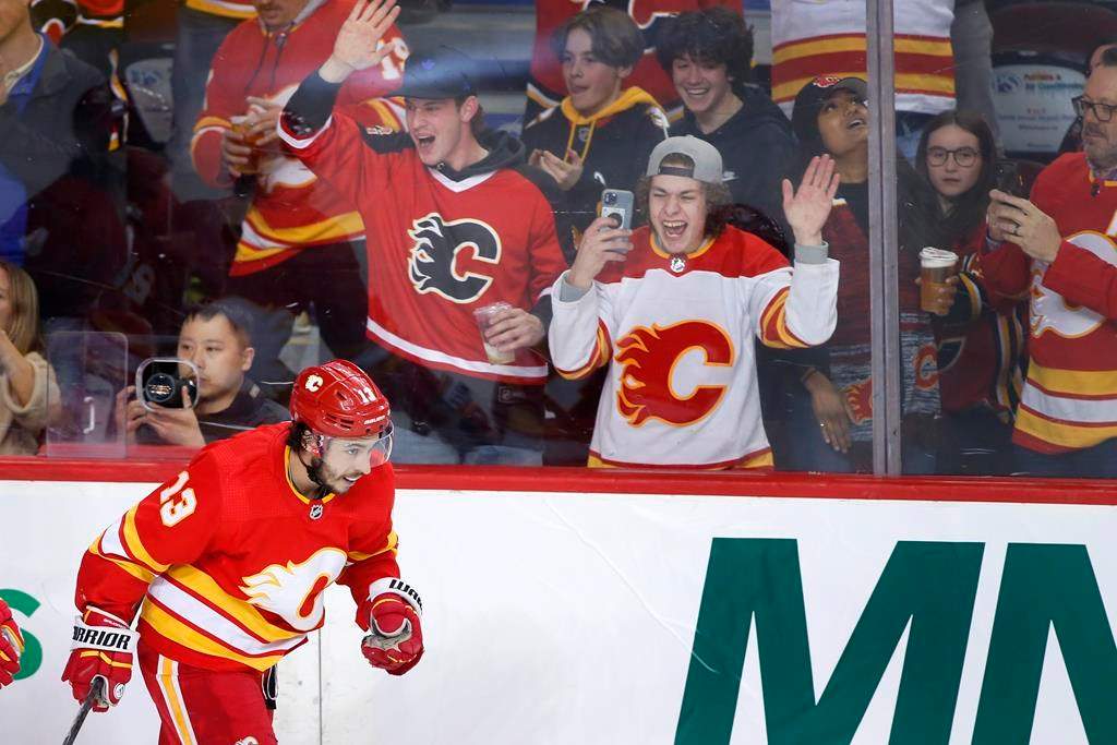 Calgary Flames left wing Johnny Gaudreau celebrates his 100th season point, an assist, during NHL hockey action against the Seattle Kraken in Calgary on April 12, 2022.