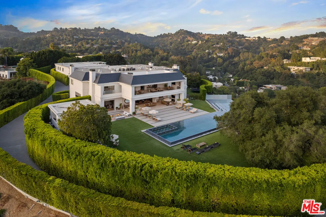 A large home sits on sprawling green grass.