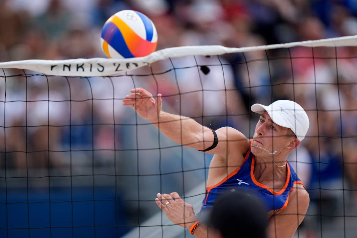 The Netherland's Steven van de Velde slams a shot over the net against Chile in a beach volleyball match at the 2024 Summer Olympics, Wednesday, July 31, 2024, in Paris, France.