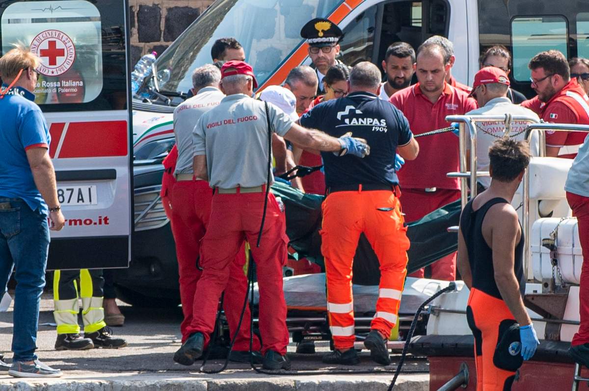 Rescuers recoup the body of one of the victims of the UK flag vessel Bayesian that sunk early Monday, Aug. 19, 2024, while at anchor off the Sicilian village of Porticello near Palermo, in southern Italy.