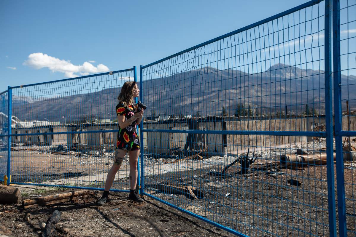 Resident Alice Foubert photographs damage in Jasper, Alberta, because she says the disaster is part of Jasper’s history, on Monday August 19, 2024. Wildfire caused evacuations and widespread damage in the National Park and Jasper townsite.