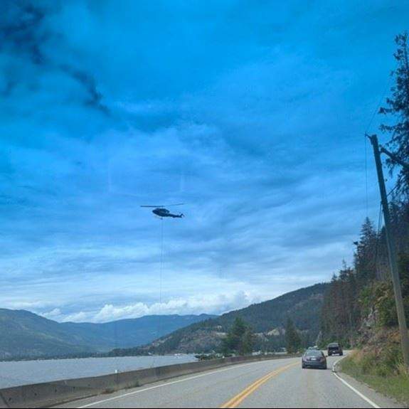 A helicopter bucketing water from Mara Lake in the Shuswap.