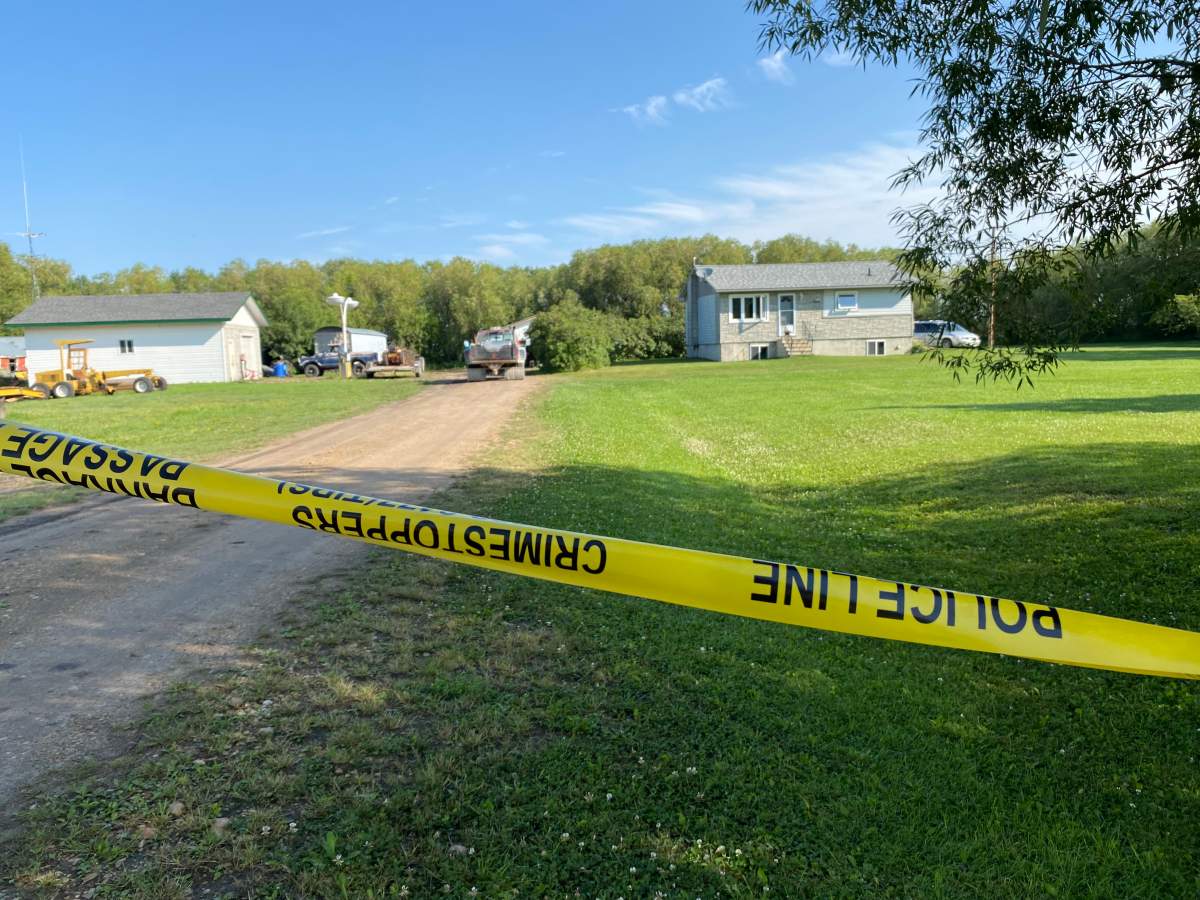 Police tape surrounds a home 10 minutes south of McCreary, Manitoba where RCMP say three bodies were found Teagan Rasche/Global News.