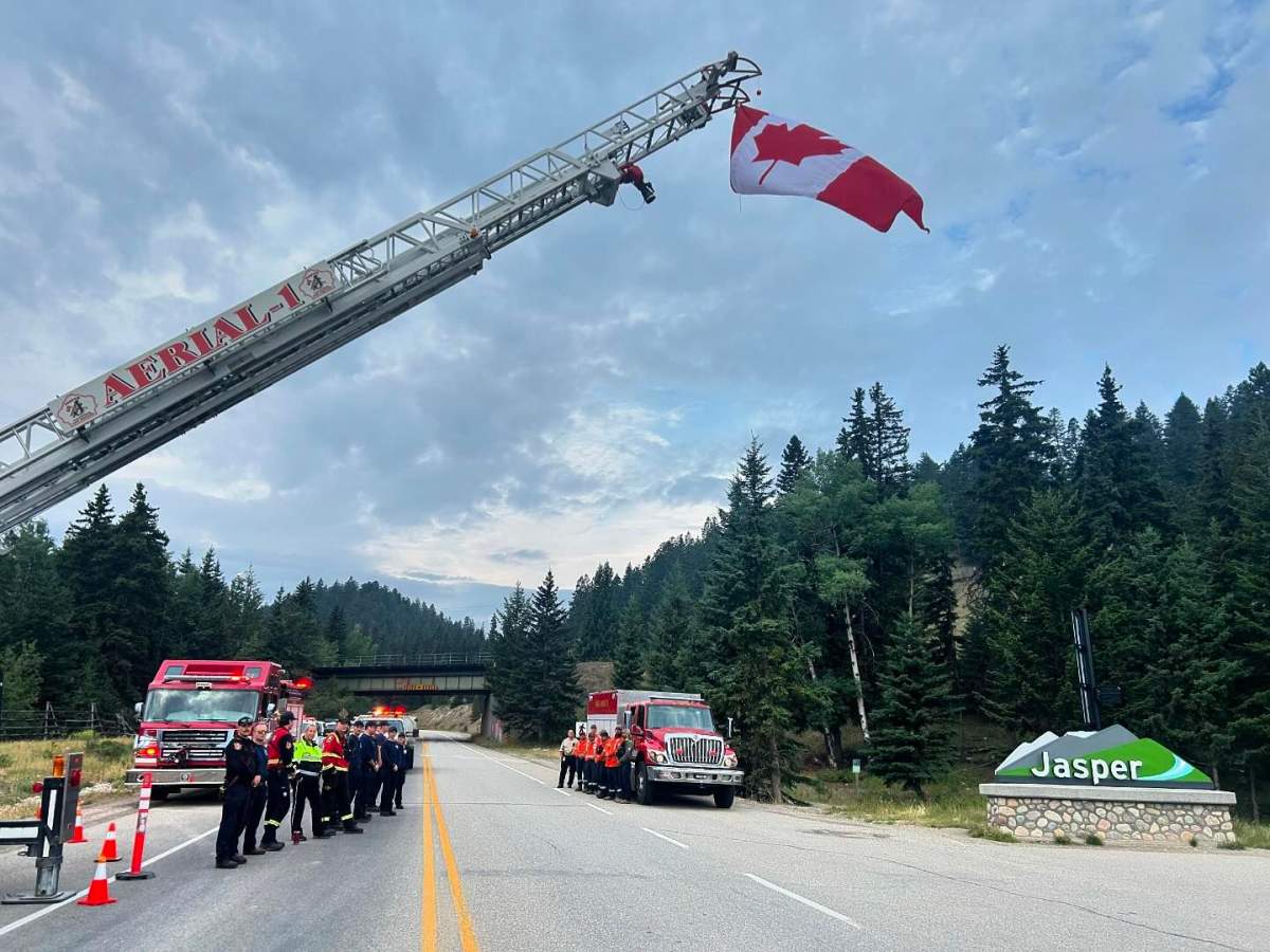 Members of the Jasper Volunteer Fire Brigade welcome residents home on Aug. 16, 2024 after a wildfire forced all of Jasper National Park to be evacuated three weeks prior.