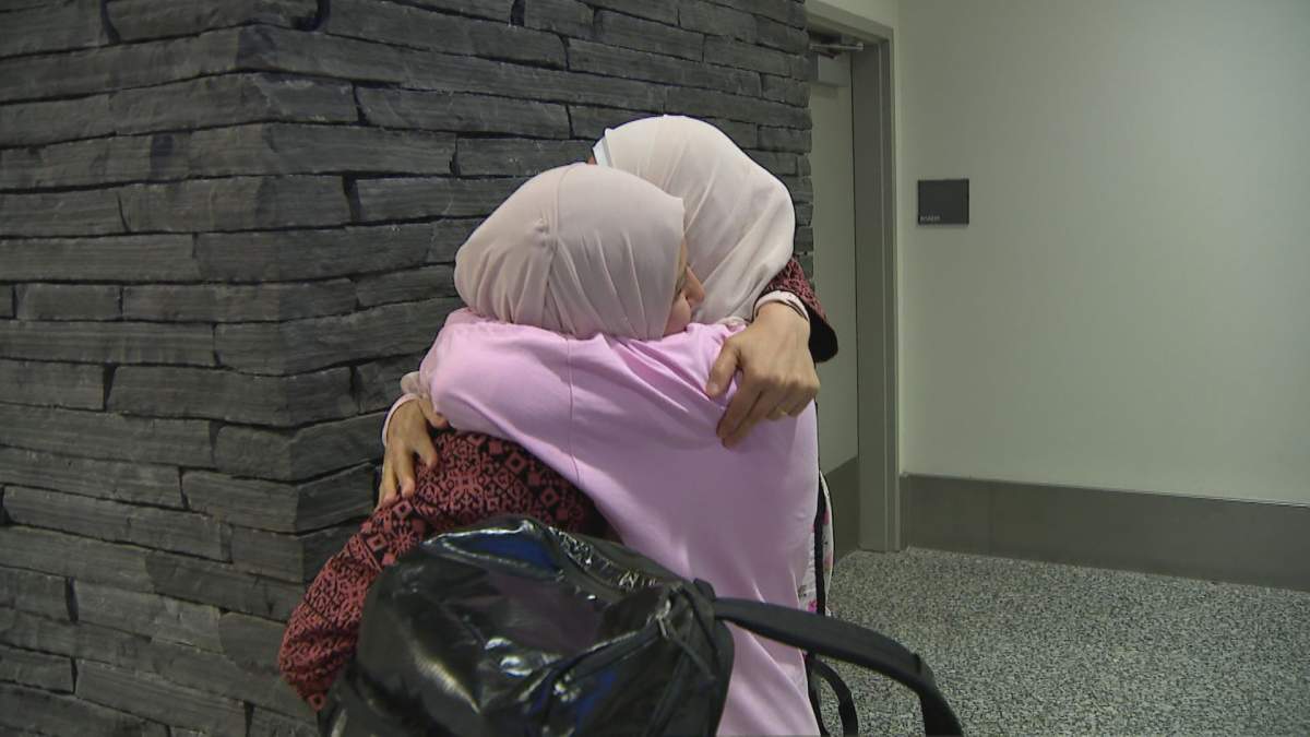 Calgary's Wafaa Dawoud embraces her sister Warda upon arrival at the Calgary International Airport on August 19, 2024. Warda Dawoud has come to Canada on a temporary visa for Gazans with relatives in Canada