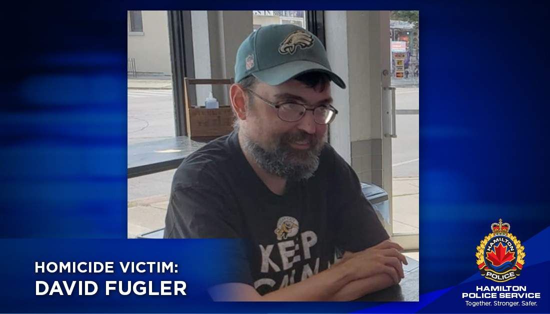 A photo of a homicide victim with a blue border and the Hamilton police crest.