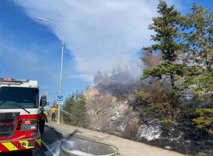 Shortly before 5pm Sunday evening, multiple 9-1-1 calls were received reporting a fire burning in the grass and trees at the Glenrosa/97 interchange at the south end of the City of West Kelowna. A plume of white smoke was highly visible across the city.