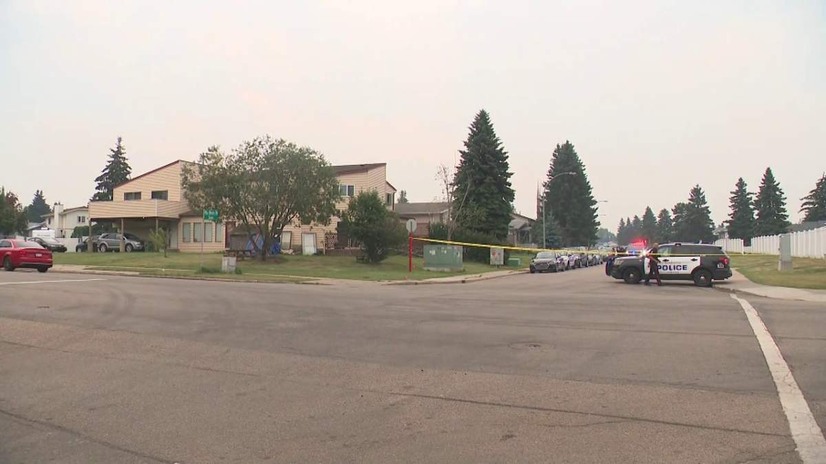 Several emergency vehicles surround a home in the area of 15th Avenue and 54th Street in Edmonton Wednesday, Aug. 14, 2024.
