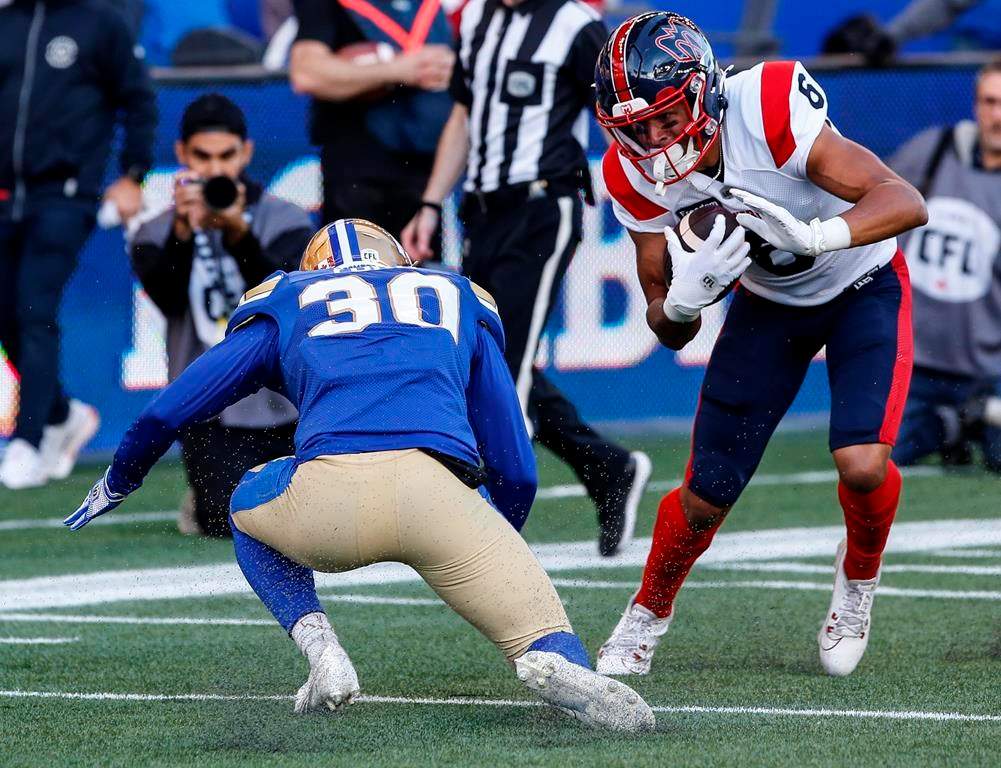 Montreal Alouettes' Tyson Philpot (6) dodges Winnipeg Blue Bombers' Tyrell Ford (30) to run the ball in for the touchdown during first half CFL action in Winnipeg, Thursday, June 6, 2024.