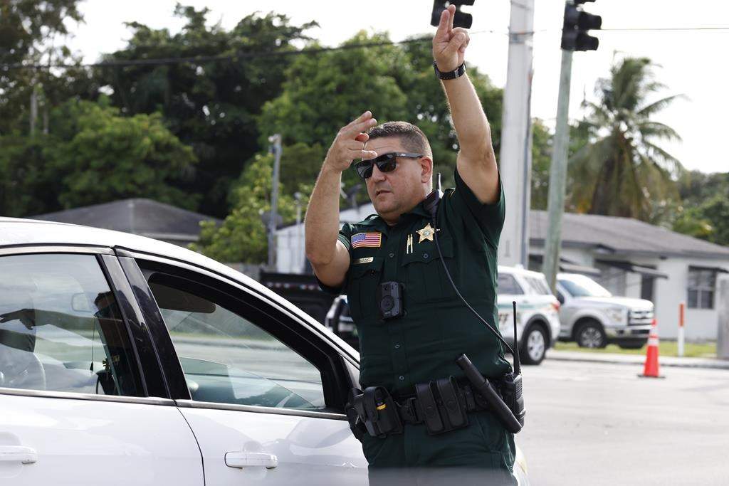 A police officer directs traffic near Trump International Golf Club after the apparent assassination attempt of Republican presidential nominee former President Donald Trump in West Palm Beach, Fla., Sunday, Sept. 15, 2024.