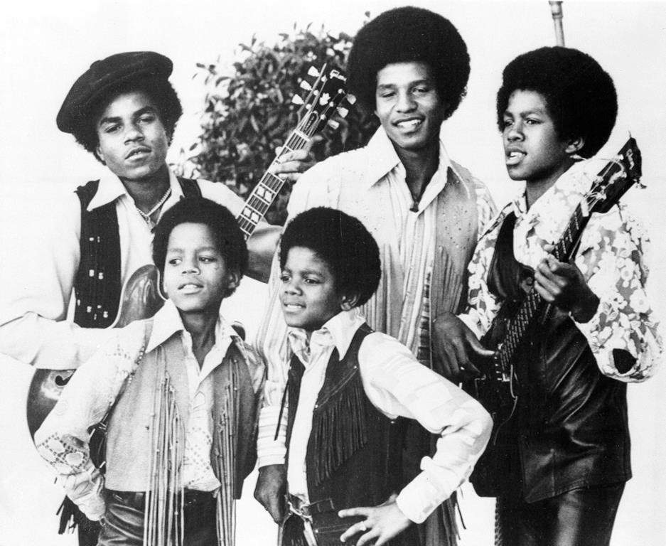 FILE - The Jackson 5, Michael Jackson, front right; Marlon Jackson, front left; Tito Jackson, back left; Jackie Jackson, back center; and Jermaine Jackson, back right; pose for this undated photo together in Los Angeles.