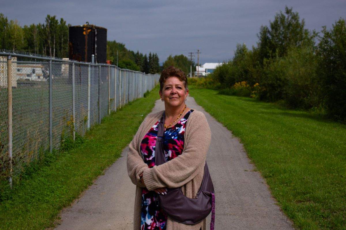 Lynn Bowes, a resident of Slave Lake, Alta., poses for a portrait at a trail near a shuttered homeless shelter on Thursday, Aug. 22, 2024. She is one of many who called on the town to close the shelter due to a perceived spike in crime.