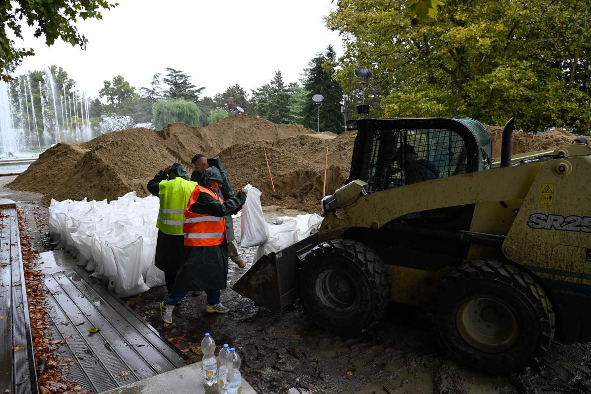 Workers of the Budapest Sewage Works build barriers with sandbags against flood water on Margaret Island in Budapest, Hungary, on Monday. (Tamas Kovacs/MTI via AP)