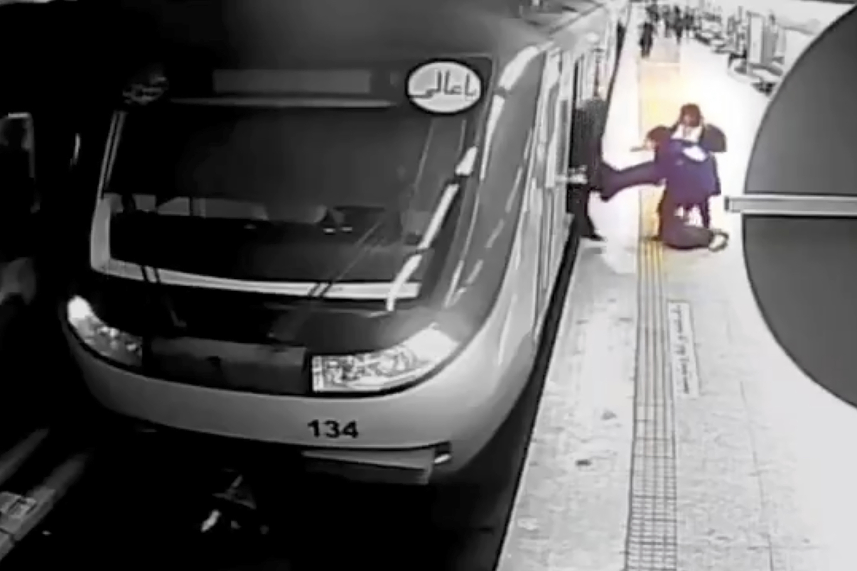 Surveillance video image shows Iranian morality police pulling 17-year-old Armita Geravand off Tehran Metro for showing her hair, Oct. 1, 2023. She later died of her injuries. (AP Photo/Iranian state television)