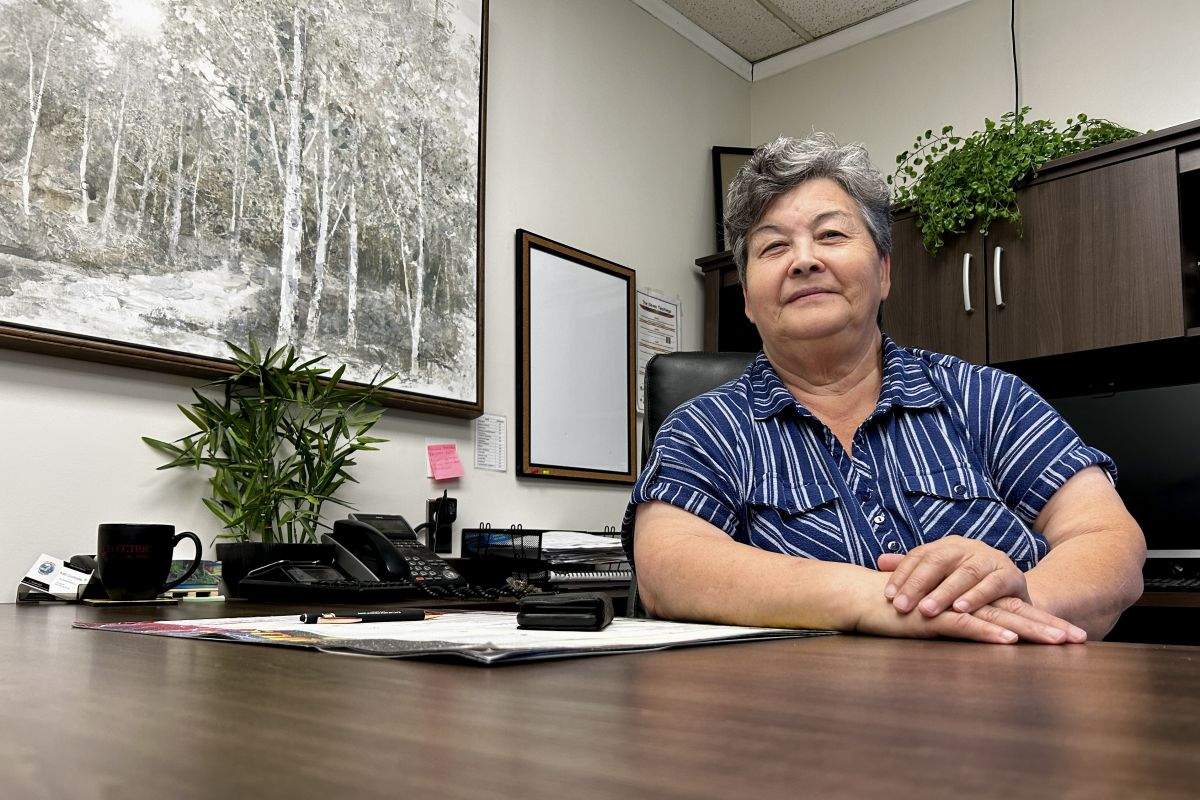 Barb Courtorielle, executive director of the Slave Lake Native Friendship Centre, sits behind a desk in her office in Slave Lake, Alta., on Thursday, Aug. 22, 2024. Courtorielle is concerned for her clients after the town's only homeless shelter closed for good.